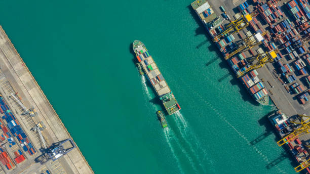 istock Container ship in export and import business logistics and transportation. Cargo and container box shipping to harbor by crane. Water transport International. Aerial view and top view. 1088998786