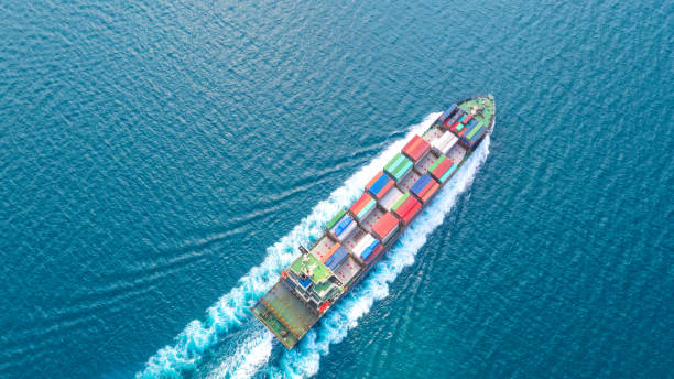 istock Container ship in export and import business logistics and transportation. Cargo and container box shipping to harbor by crane. Water transport International. Aerial view and top view. 1088998788