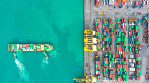 istock Container ship in export and import business logistics and transportation. Cargo and container box shipping to harbor by crane. Water transport International. Aerial view and top view. 1088998790
