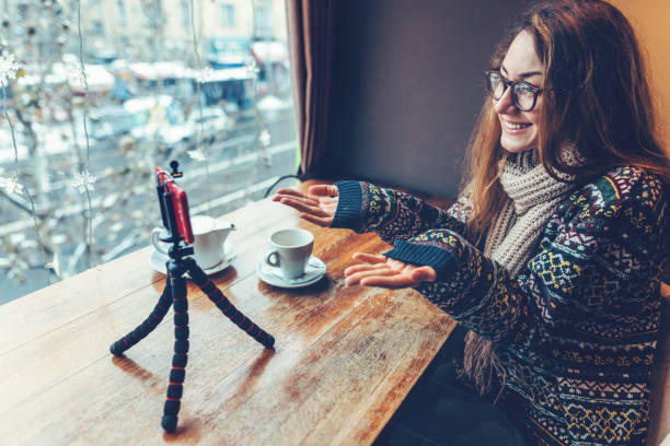 istock Cheerful woman vlogging at the cafeteria 1088999136