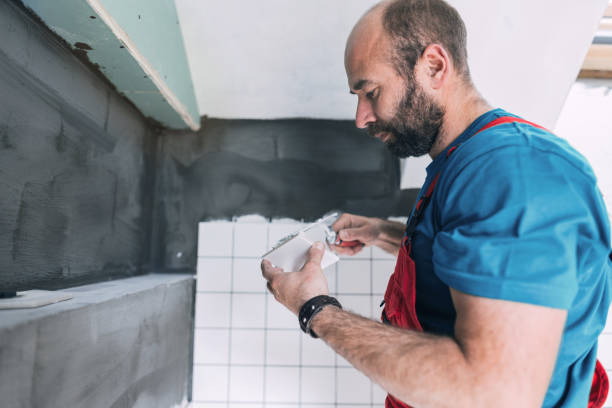 istock Male tiler installing tiles on the bathroom wall 1088999174
