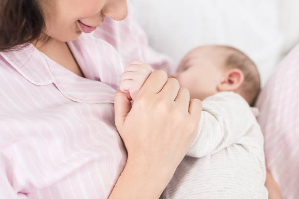 istock partial view of cute baby sleeping on mothers hands 1089000130