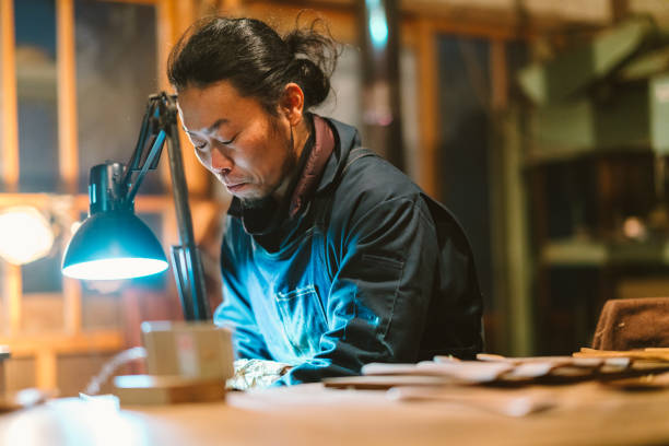 istock Asian man making craft from wood 1089003004