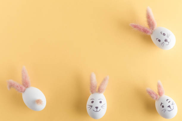 istock Easter eggs cute bunny. Funny decoration on yellow pastel desk background. Happy Easter, top view and flat lay 1089008488