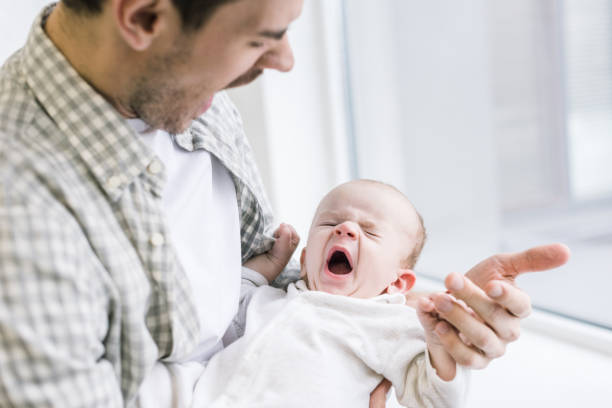 istock young father copying son while he yawning at home 1089012100