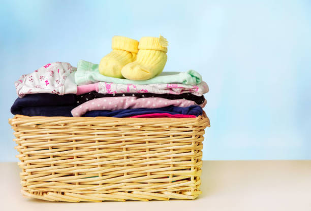 istock A stack of children's clothes in a basket on the table 1089016108