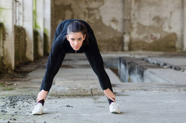 istock Young ballerina warming up before exercising 1089016114