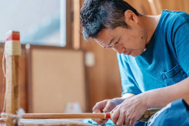 istock Asian man making broom in his working space 1089016468