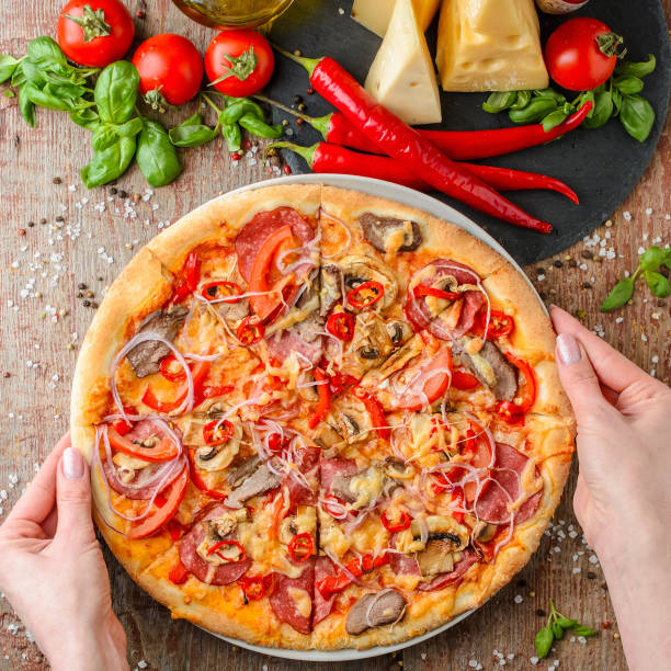 istock Woman hands takes pizza on a plate, top view 1089021512