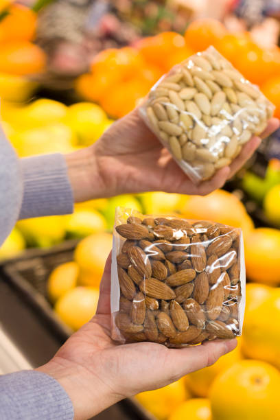 istock Female hand choosing almonds in the store 1089021950