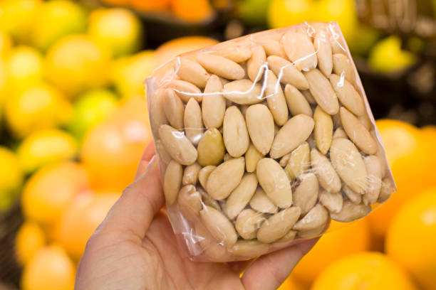istock Female hand choosing almonds in the store 1089021962