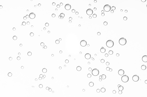 Many small light water drops isolated over a white background.