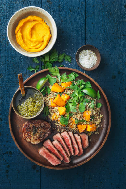 istock Filet mignon with chimichurri and quinoa salad with caramelised and mashed pumpkin 1089024380