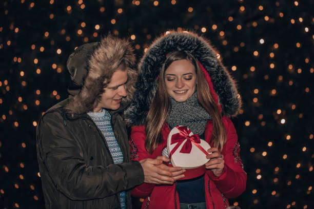 istock Young couple together opens box with a gift 1089024986