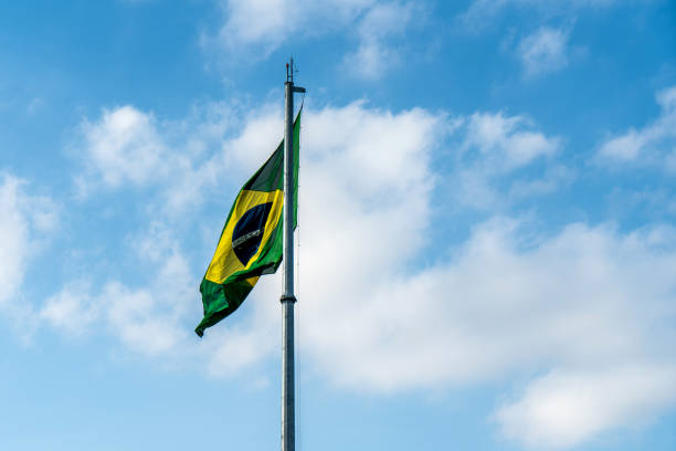 istock Brazilian Flag Waving Against a blue sky background. 1089026126