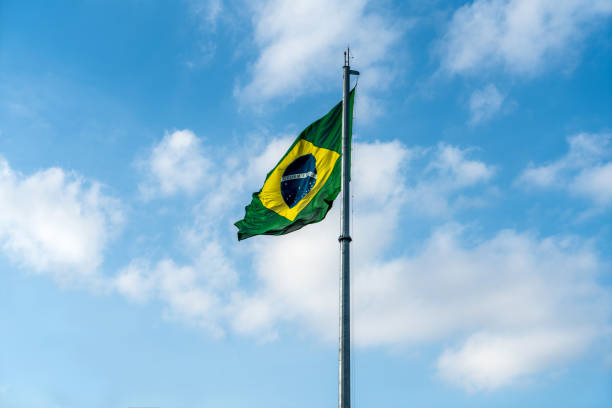 istock Brazilian Flag Waving Against a blue sky background. 1089026140