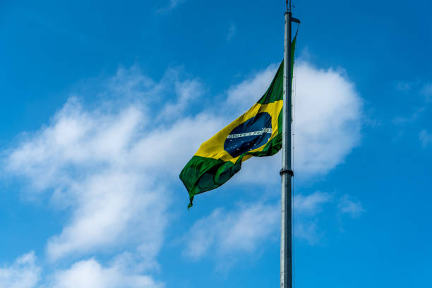 istock Brazilian Flag Waving Against a blue sky background. 1089026142