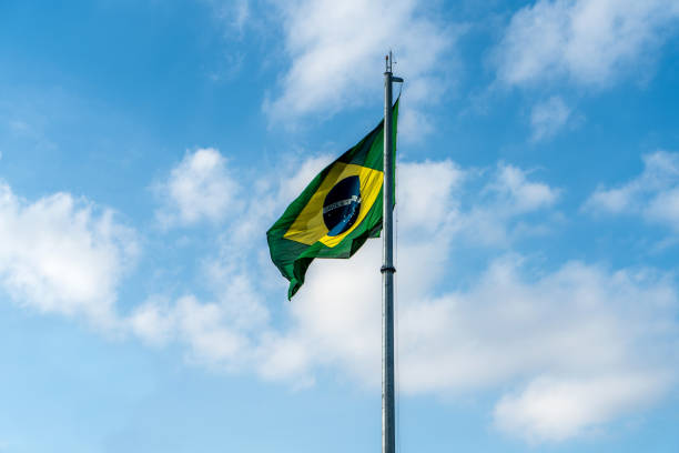istock Brazilian Flag Waving Against a blue sky background. 1089026154