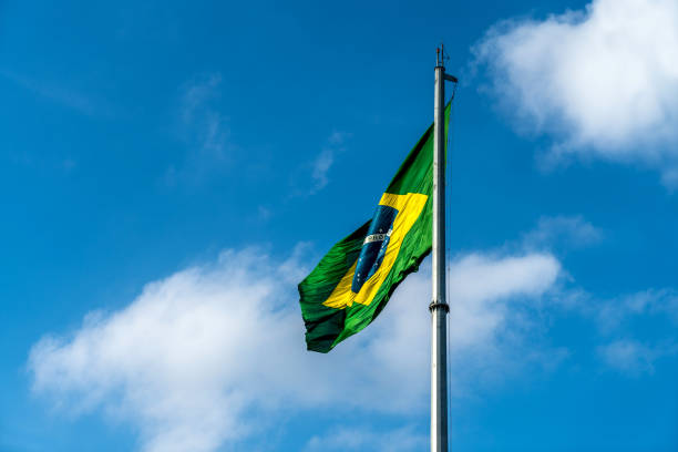 istock Brazilian Flag Waving Against a blue sky background. 1089026184