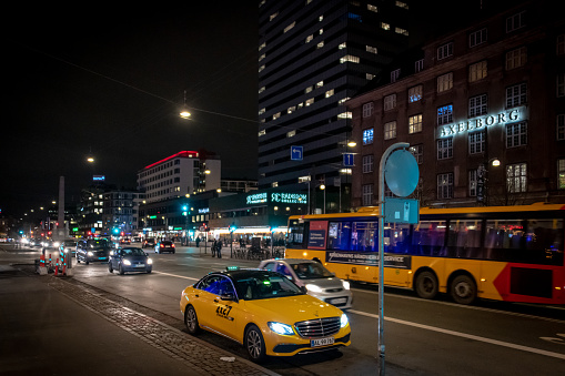 Copenhagen, Denmark. 28th December 2018. City traffic in central Copenhagen with taxis, buses and pedestrians at nighttime.