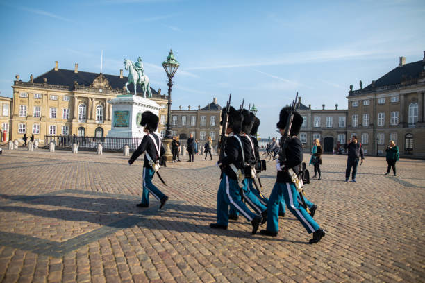 Copenhagen, Denmark. 30th December 2018. Soldiers in ceremonial uniform outside Amalienborg Palace, as tourists watch the daily Changing of the guard in Copenhagen, Denmark.