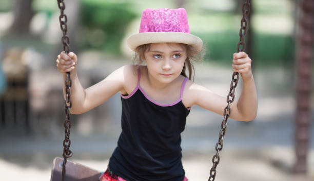 Little girl on a swing outdoors