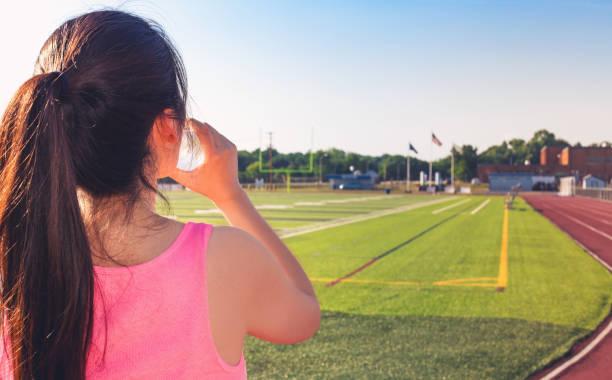 istock Female athlete drinking water on a running track 1089035752