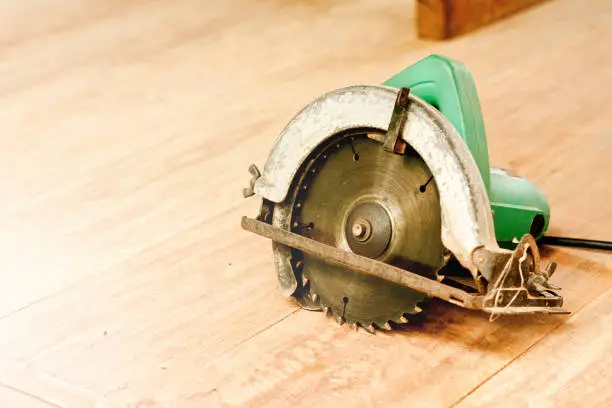 circular saw or power saw on wooden background tool woodcraft object isolated
