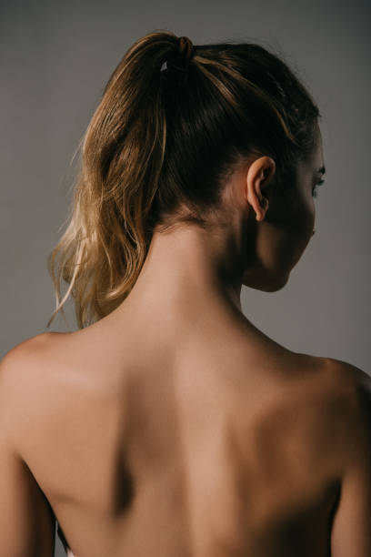 istock back view of girl with ponytail on grey background 1089036290
