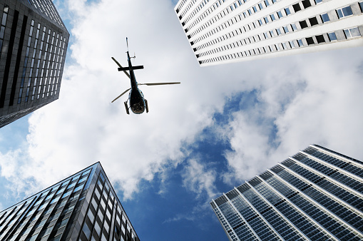 Helicopter flying over buildings in New York City