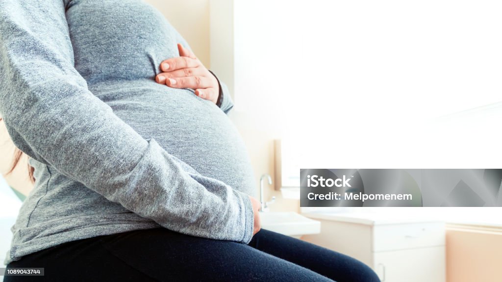 Pregnant woman at the hospital Pregnant woman at the hospital for a prenatal checkup Care Stock Photo