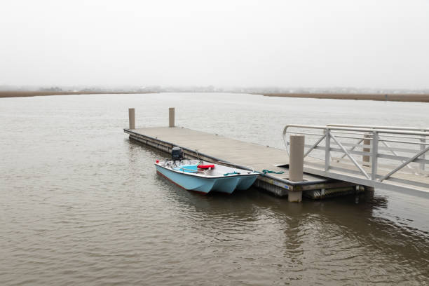 Boating on Edisto Island A fishing skiff tied up at a public dock on a creek on Edisto Island, SC. edisto island south carolina stock pictures, royalty-free photos & images