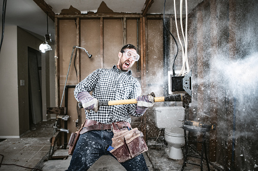 A man attempts to work on renovating his home, with funny and disastrous results.  He swings a sledgehammer, taking out part of a wall.