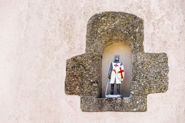 Rochefort-en-Terre, France. Templar knight figure resting in a niche on a wall