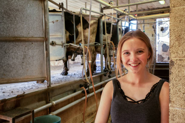 istock A Young Woman Taking A Break While The Milking Machines Milk The Cows 1089052894