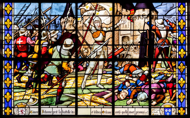 Stained glass window with Joan of Arc Fougeres, France. Stained glass window representing Joan of Arc after the Siege of Orleans, Eglise Saint-Sulpice church relieves stock pictures, royalty-free photos & images