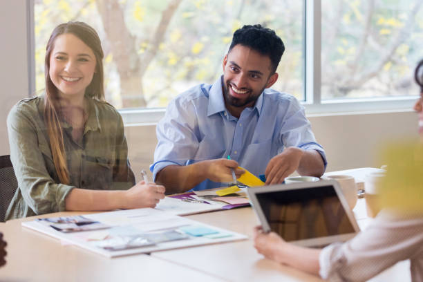 istock Group of young creative people smile with one another during their meeting 1089055760