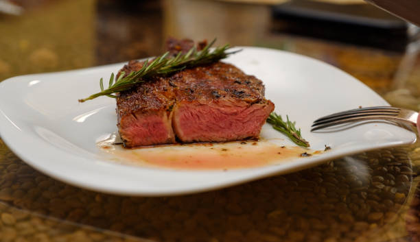 istock Beef steak with a sprig of rosemary on a plate. Image. 1089057080