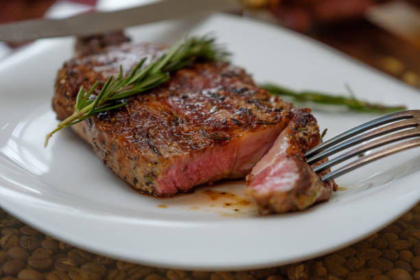 istock Beef steak with a sprig of rosemary on a plate. Image. 1089057082