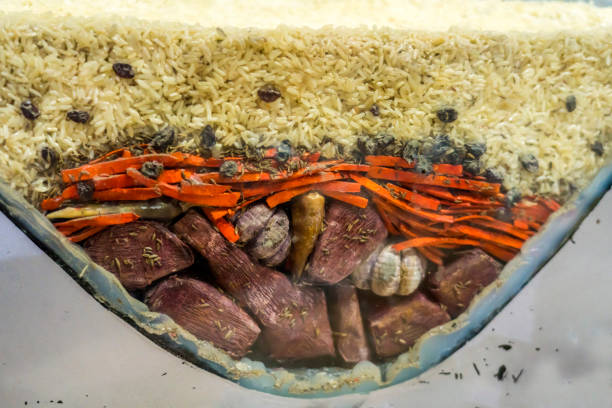 Pilaf rice cooked on traditional stove, is a national dish of Uzbekistan that is cooked from rice, carrot, garlic, meat and raisins.