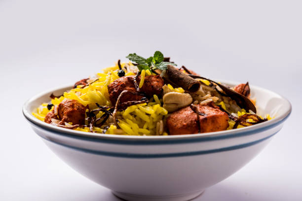 istock Indian Chicken Tikka Biriyani served in a bowl with yogurt. selective focus 1089061018