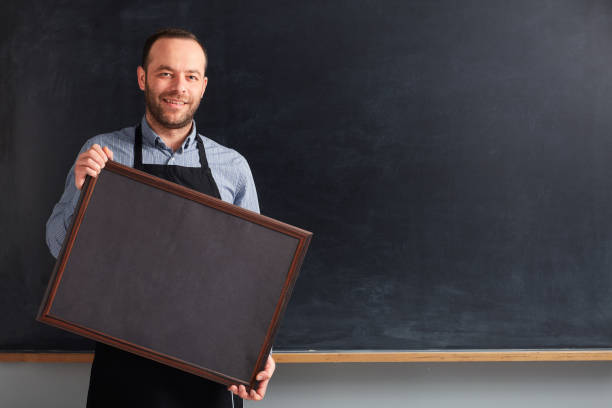 istock Cafe worker holding placard on blackboard. 1089061670