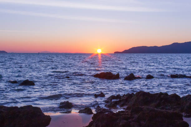 istock The sun is hiding the beach edge 1089063582
