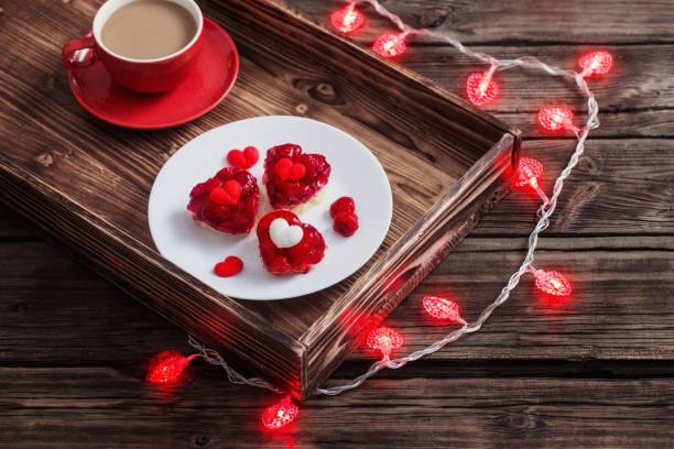 heart-shaped cakes and  cup of coffee on  wooden table - raspberry heart shape gelatin dessert valentines day imagens e fotografias de stock