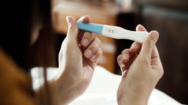 Positive pregnancy test in female hands