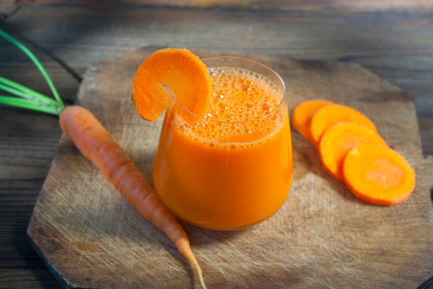 istock Carrot juice in glass on  table 1089078848