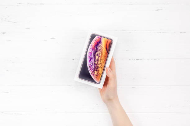 Woman hands with latest Apple iPhone XS box stock photo
