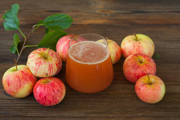 Delicious fresh squeezed apple juice in a transparent glass