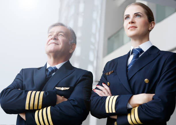 Confident pilots looking through the window Cabin Crew, Pilot, Co-Pilot, Adult piloting stock pictures, royalty-free photos & images