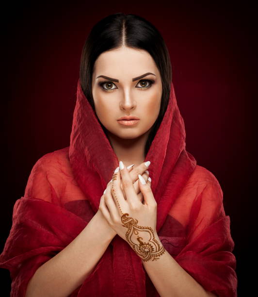 istock Studio, face, brown eyes, red shawl, drawing mehendi, red background 1089084026